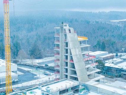 Unfinished building in winter with crane and snow-covered surroundings, Nagold, Häfele, Black