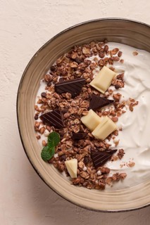Yogurt with chocolate muesli, breakfast, close-up, fork on top, no people