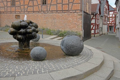 Mathildenbrunnen fountain with sculpture and balls, Butzbach, Wetterau, Hesse, Germany, Europe