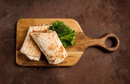Cut shawarma, 2 pieces, on a cutting board, close-up