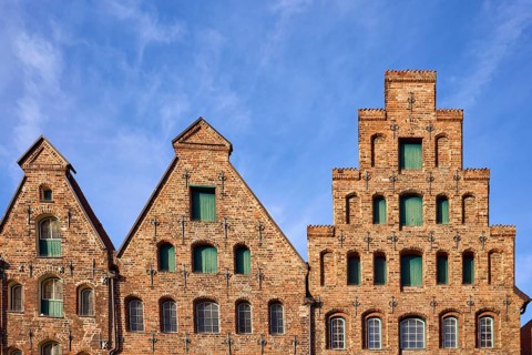 Historic salt warehouse, brick building, gable against blue sky with veil clouds, Hanseatic city of
