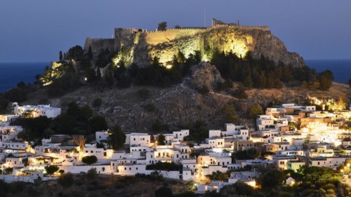 Night view of an illuminated fortress above a quiet village with winding streets, Acropolis of