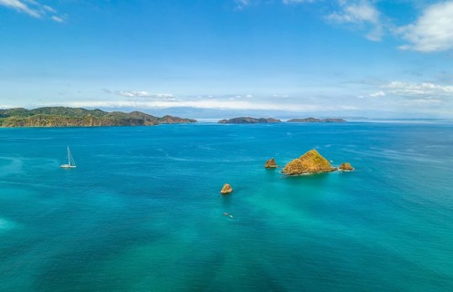 Aerial view, tropical islands and sailing boat in the turquoise ocean, Tortuga Island, Puntarenas,
