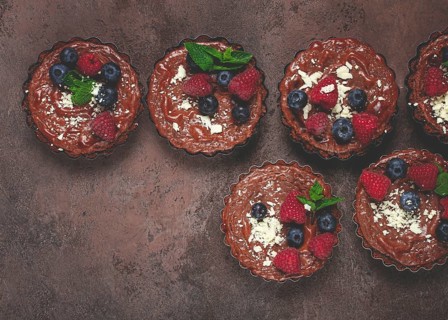 Chocolate tartlets, stuffed with cottage cheese and berries, breakfast, homemade, no people
