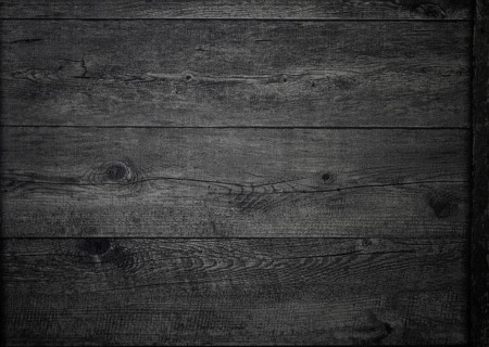 The rich, dark wood surface features intricate grain patterns and textures, creating a warm and