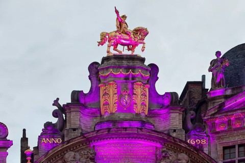 The illuminated golden horseman Charles de Lorraine on the guildhall L'Arbre d'Or, Guild of