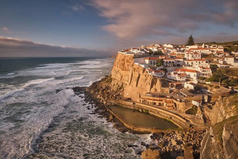 Scenic view of the seaside Azenhas do Mar fishing village on cliff on Atlantic ocean coast,