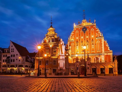 Riga Town Hall Square, House of the Blackheads and St. Roland Statue illuminated in the evening