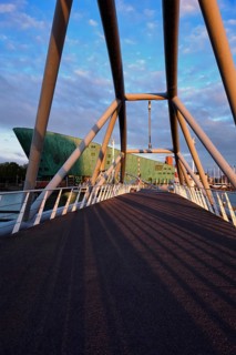 AMSTERDAM, NETHERLANDS, MAY 9, 2017: NEMO Science museum and Mr. J. van der Veldebrug bridge. It is