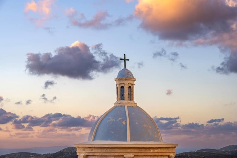 Blue dome of the Holy Catholic Church of Our Lady of Mount Carmel, dramatic cloudy sky, at sunrise,
