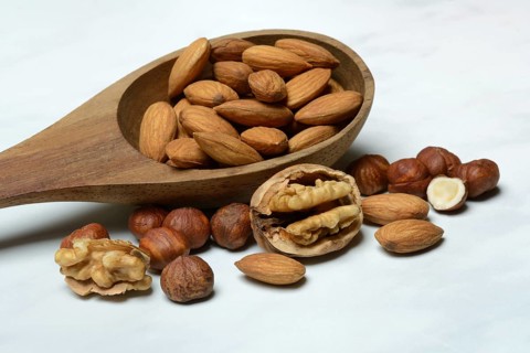 Wooden ladle with various nuts