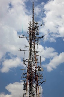 Overloaded antenna mast, here in Naples, Campania, Italy, Europe