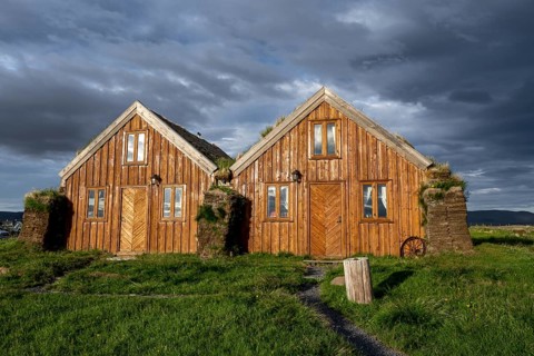 Traditional wooden peat houses with grass on the roof, in the evening light, Möðrudalur, Icelandic