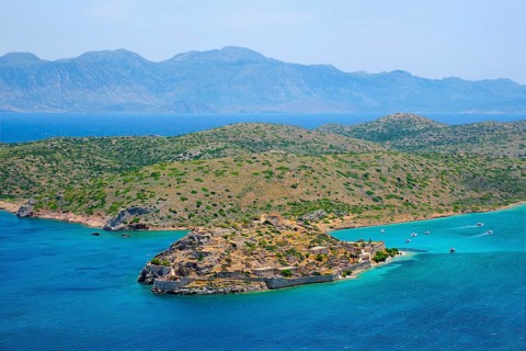 Island of Spinalonga with old fortress former leper colony and the bay of Elounda, Crete island,