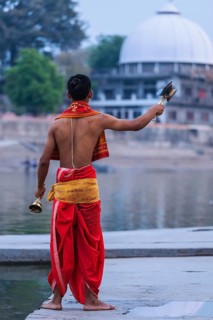 UJJAIN, INDIA, APRIL 23, 2011: Brahmin performing Aarti pooja ceremony on bank of holy river