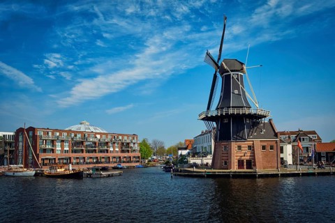 View of Harlem landmark windmill De Adriaan on Spaarne river. Harlem, Netherlands
