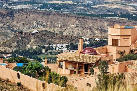 Luxury holiday home on the hillside, Moorish style with terrace and red dome, view from above,