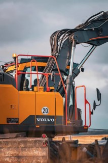 Yellow Volvo tracked excavator on construction site