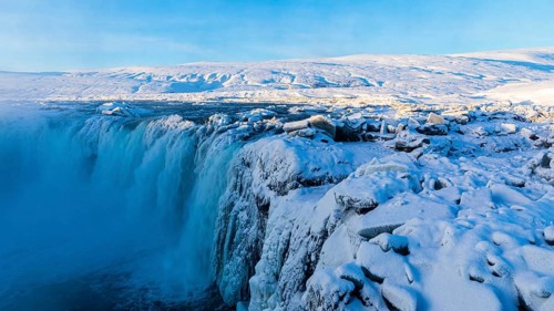 Godafoss waterfall in first morning sun, snow-covered landscape, Northern Iceland Eyestra, Iceland,