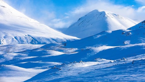 Light and shadow over snowy hilly landscape, near Akureyri, Northern Iceland Eyestra, Iceland,