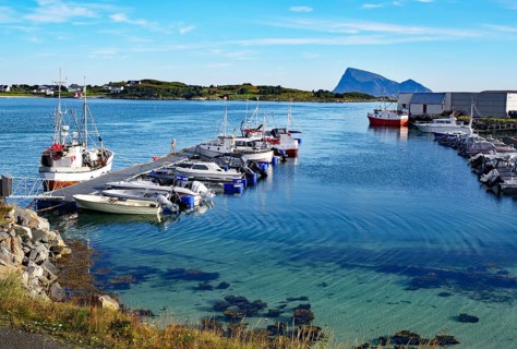 Crystal clear bays and sandy beaches on Sommarøy, small pleasure boats and fishing boats, summer,