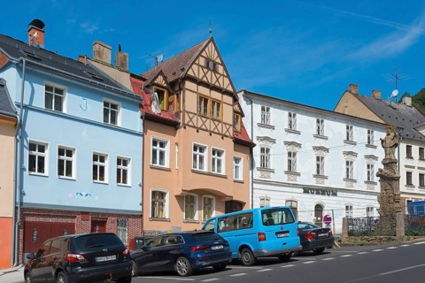 Old town with Renaissance-style museum, plague column column on the right, Krupka, Graupen,