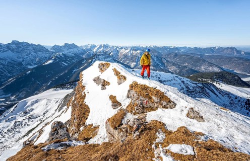 Ski tourers at the summit of Schafreuter, view of snow-covered mountain panorama, Karwendel, Tyrol,