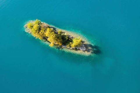 Bird's eye view of the chive island in the turquoise waters of Lake Walen in the canton of St.