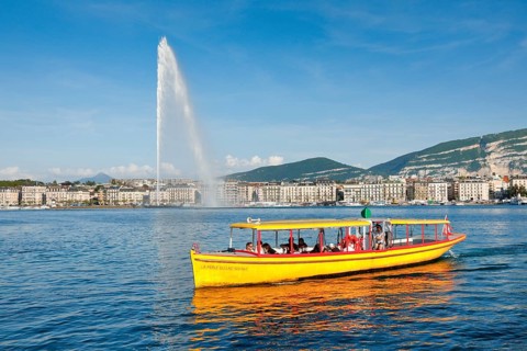 The Jet d'eau, and the Mouettes genevoises in sunshine and blue sky, landmark in the Geneva harbour