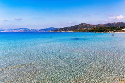 Turquoise blue clear water, coastline with hills on the horizon, L'Île-Rousse, Ile Rousse,