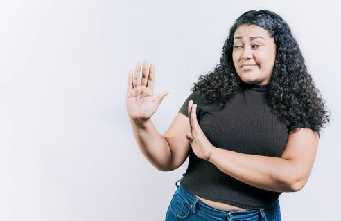 Displeased young woman rejecting with palms hands isolated. Disgusted young woman with rejection