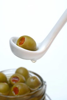 Green olive stuffed with pieces of paprika