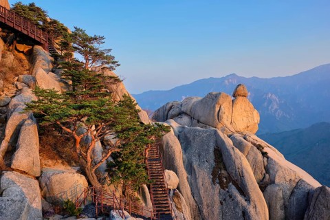 View of stones and rock formations from Ulsanbawi rock peak on sunset with staircase. Seoraksan