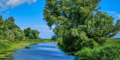 Picturesque river landscape, view from the heritage-protected wooden bascule bridge over the Trebel