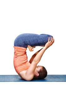 Sporty fit yogini woman practices inverted yoga asana Urdhva padmasana, lifted lotus pose isolated