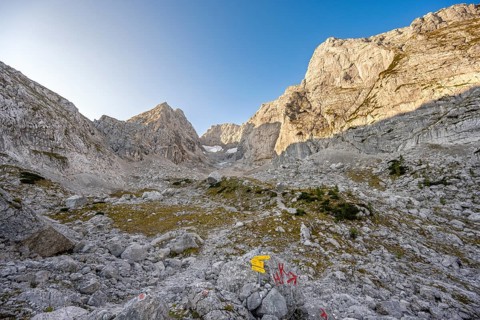 Rocky mountain peaks Blaueisspitze and Hochkalter at sunrise, hiking trail with markings, mountain