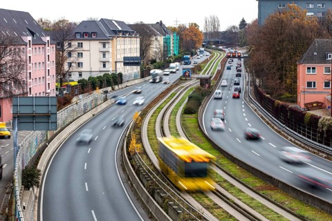 Motorway A40, Ruhrschnellweg, skyline of the city centre of Essen, exit Essen-Huttrop, track bus