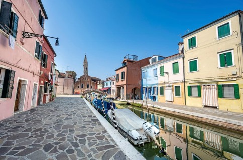 Colourful houses on the canal with reflection, canal with boats and colourful house facades, in the