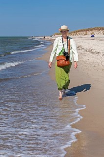 Elderly woman walking barefoot on the beach, Darßer Ort, Born a. Darß, Mecklenburg-Vorpommern,