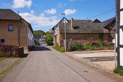 Street with residential buildings, sandstone buildings and half-timbered houses in the district of
