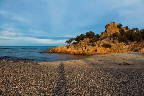 Lonely picturesque beach and red rocks, Spiaggia Su Sirboni, sunset, near Tertenia, Province of