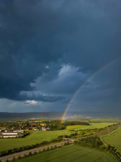 Thunderstorm cell with rainbow over fields near Krebs in the Osterzgebirge, Krebs, Saxony, Germany,