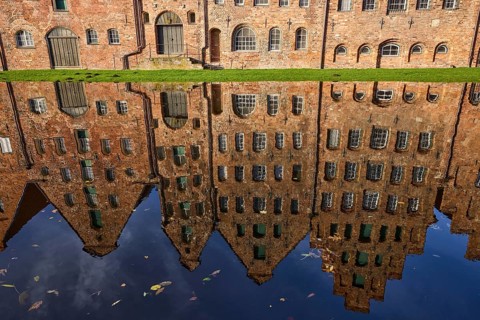 Salt warehouse, historic brick buildings, reflections on the water surface of the Trave, Hanseatic