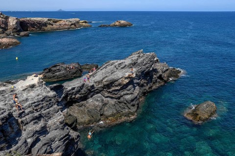 Cliff jumper at Cabo de Palos, near La Manga del Mar Menor, Murcia Province, Costa Cálida, Spain,