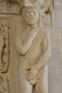 Adam with a fig leaf on the western gate of Trogir Cathedral or Cathedral of St. Lawrence, 13th