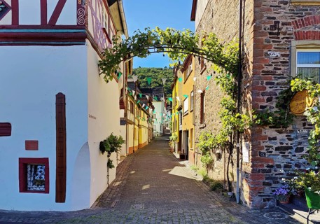 Decorated narrow lane at the Storchenhaus half-timbered house with wine arch and high-water marks,