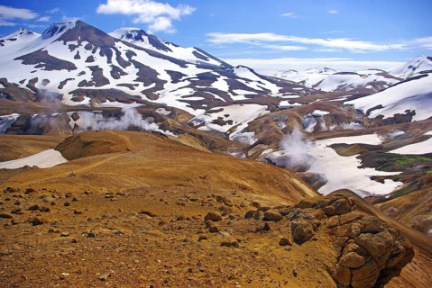 Snow-covered, volcanic landscapes, smoke and vapour drift over brown surfaces, highlands, fire and