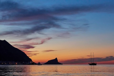 Sunset, dusk, grey clouds, sailboat, Castello di Punta Troia, boat tour, view from the sea,