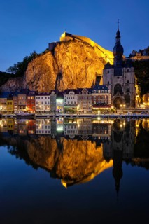 Night view of Dinant town, Collegiate Church of Notre Dame de Dinant over River Meuse and Pont