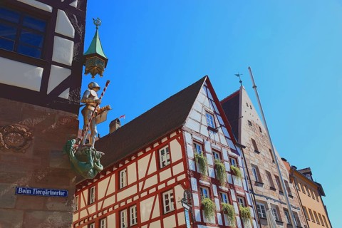In the historic centre of Nuremberg, St. George as dragon slayer at Pilatus House (left) and houses
